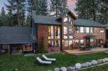 Experience luxury living in this stunning lakefront home, boasting expansive windows that offer breathtaking water views and abundant natural light.