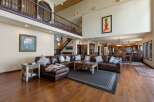 Experience luxurious living in this expansive great room, featuring a grand two-story layout and a stunning leather sectional.