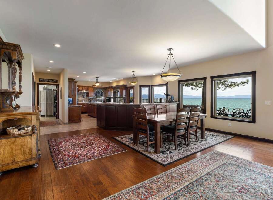 Experience breathtaking lake views from this stunning open-concept living space, featuring a gourmet kitchen and a spacious dining area perfect for entertaining.