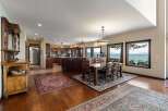 Experience breathtaking lake views from this stunning open-concept living space, featuring a gourmet kitchen and a spacious dining area perfect for entertaining.