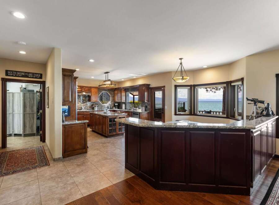 Experience breathtaking lake views from this stunning kitchen and dining area, perfect for entertaining.