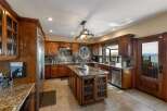 Experience breathtaking lake views from this stunning kitchen, featuring rich cherry wood cabinetry and granite countertops.