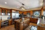 Experience luxury in this stunning kitchen featuring custom wood cabinetry and granite countertops.