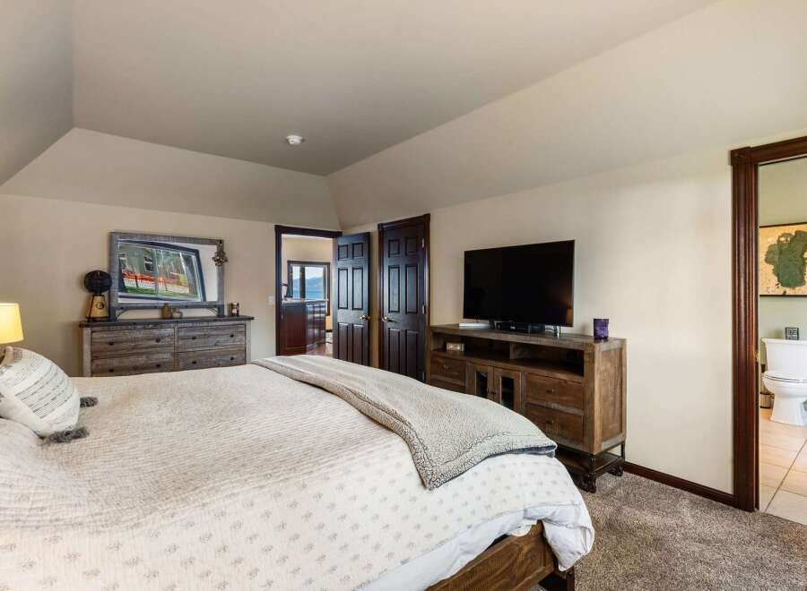 Experience ultimate comfort in this spacious master bedroom, featuring a plush king-sized bed and a cozy reading nook.