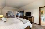 Experience ultimate comfort in this spacious master bedroom, featuring a plush king-sized bed and a cozy reading nook.