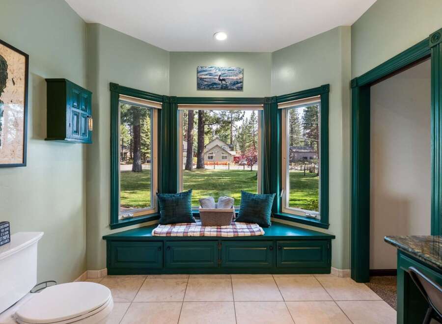 Enjoy serene views from this charming bay window seat, perfect for a quiet morning coffee or reading a book.
