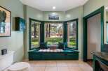 Enjoy serene views from this charming bay window seat, perfect for a quiet morning coffee or reading a book.