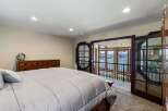 Wake up to breathtaking lake views from this stunning bedroom, featuring a spacious master suite with direct access to a private balcony.