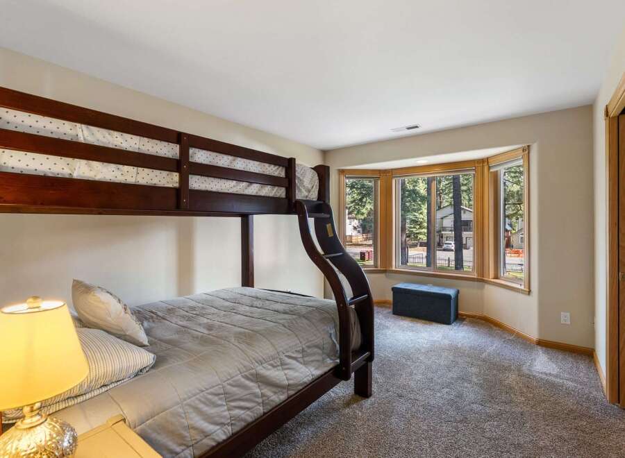 This charming bedroom features a sturdy wooden bunk bed, perfect for accommodating guests or family.