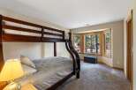 This charming bedroom features a sturdy wooden bunk bed, perfect for accommodating guests or family.