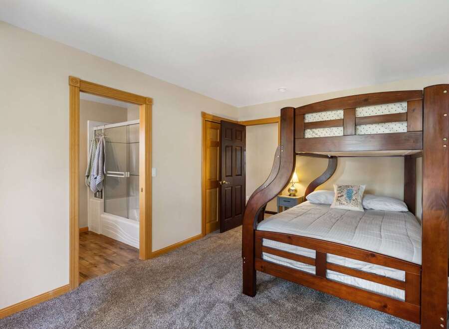 This charming bedroom features a sturdy wooden bunk bed, perfect for accommodating guests or family.