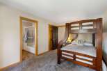 This charming bedroom features a sturdy wooden bunk bed, perfect for accommodating guests or family.