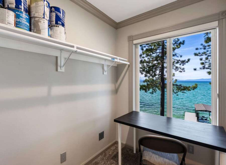 Enjoy breathtaking lake views from this charming room, perfect for a home office or creative space.