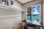 Enjoy breathtaking lake views from this charming room, perfect for a home office or creative space.