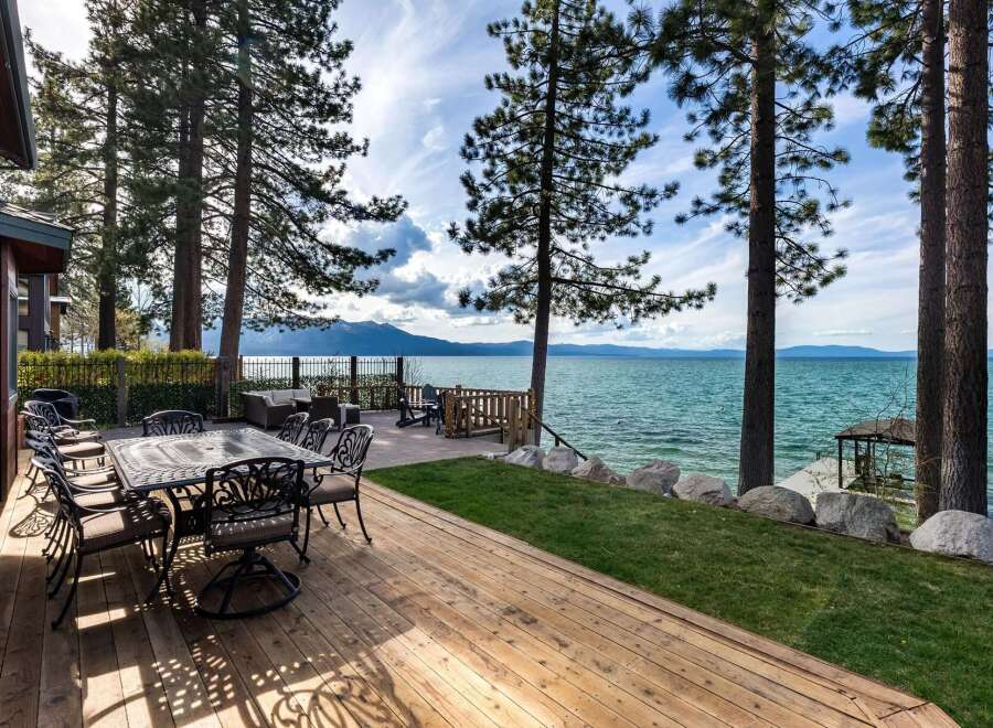 Enjoy breathtaking lake views from this stunning waterfront property, featuring a spacious deck perfect for outdoor entertaining.