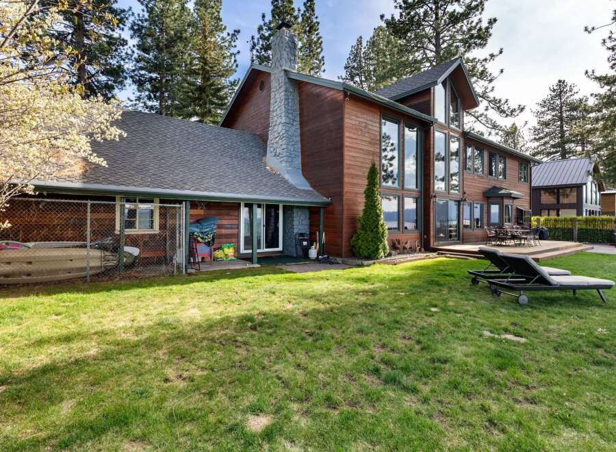 Experience luxury living in this stunning lakefront property, featuring expansive windows that offer breathtaking water views.