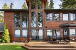 Experience luxury living in this stunning lakefront property, featuring expansive windows that offer breathtaking views of the water and surrounding mountains.