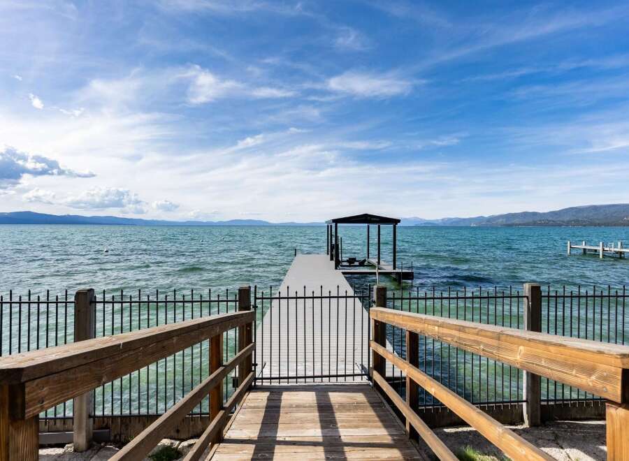Enjoy breathtaking lake views from this stunning property featuring a private dock with a covered boat slip.