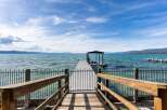 Enjoy breathtaking lake views from this stunning property featuring a private dock with a covered boat slip.