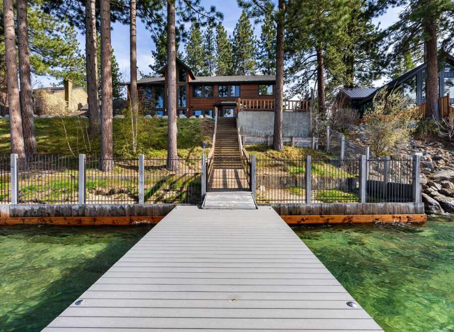 Experience luxury lakeside living with this stunning property featuring a private dock and breathtaking water views.