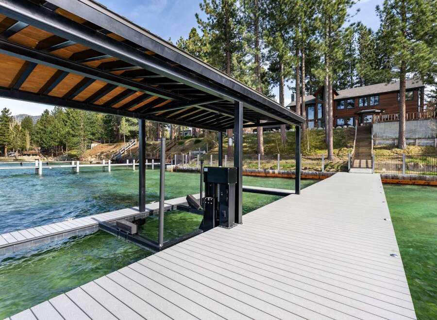 Experience luxury lakeside living with this stunning property featuring a private dock and boat lift, perfect for enjoying all your favorite water activities.