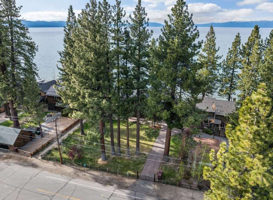 Experience serene lakefront living with this stunning property, nestled amidst towering pine trees and offering breathtaking views of the water.
