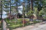 Experience lakeside living in this stunning property, featuring a spacious home nestled among mature trees with breathtaking water views.
