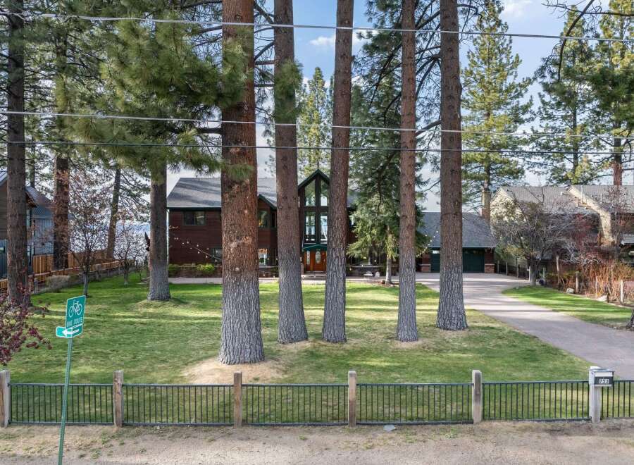 Nestled among mature pine trees, this stunning property offers a serene retreat with a beautiful lake view.