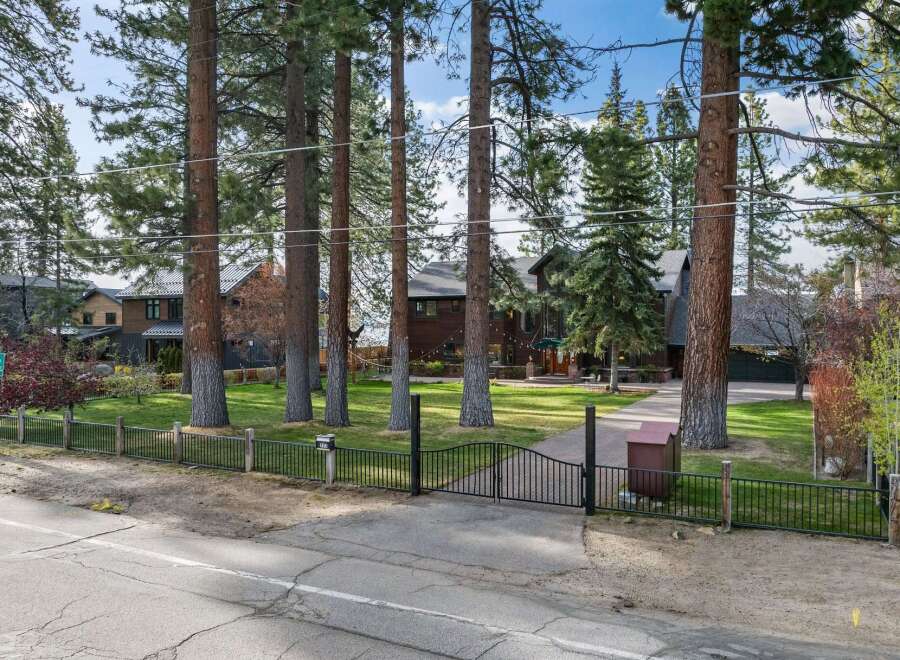 Discover this stunning property featuring a grand entrance with a paved driveway leading to a beautiful home.