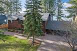 Experience luxury living in this stunning lakefront property, nestled amidst towering pine trees.