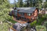 Experience luxury living in this stunning lakefront property, boasting a spacious wooden deck perfect for entertaining and a beautifully landscaped backyard.