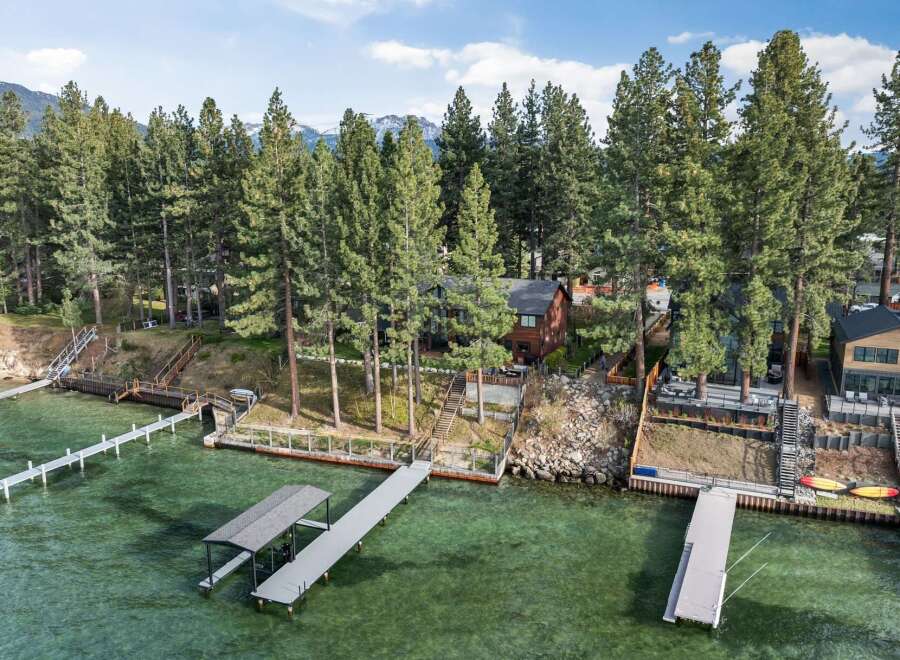 Experience luxury lakeside living with this stunning property featuring multiple private docks and boat lifts, perfect for water enthusiasts.