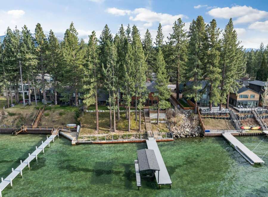 Experience luxury lakeside living with this stunning property featuring multiple private docks and boat houses, perfect for water enthusiasts.