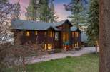 Experience luxury living in this stunning custom-built home, nestled amidst towering pine trees.