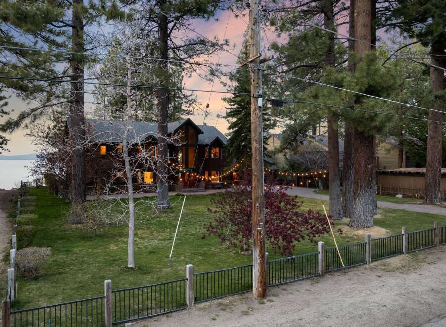 Experience serene lakeside living in this stunning property, nestled amongst mature trees with breathtaking water views.