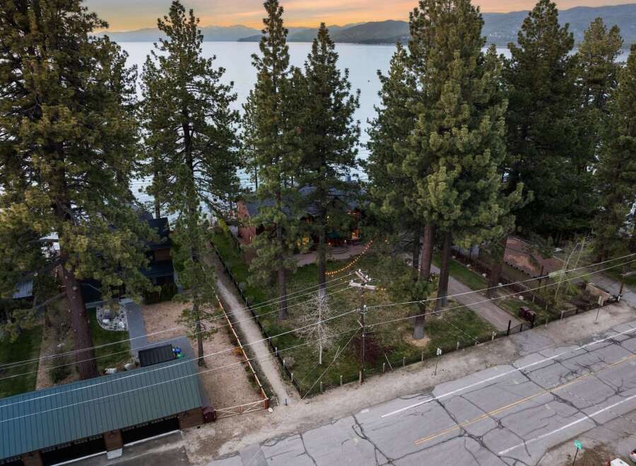 Experience luxury lakeside living in this stunning property, nestled among towering pine trees with breathtaking views of the water and mountains.