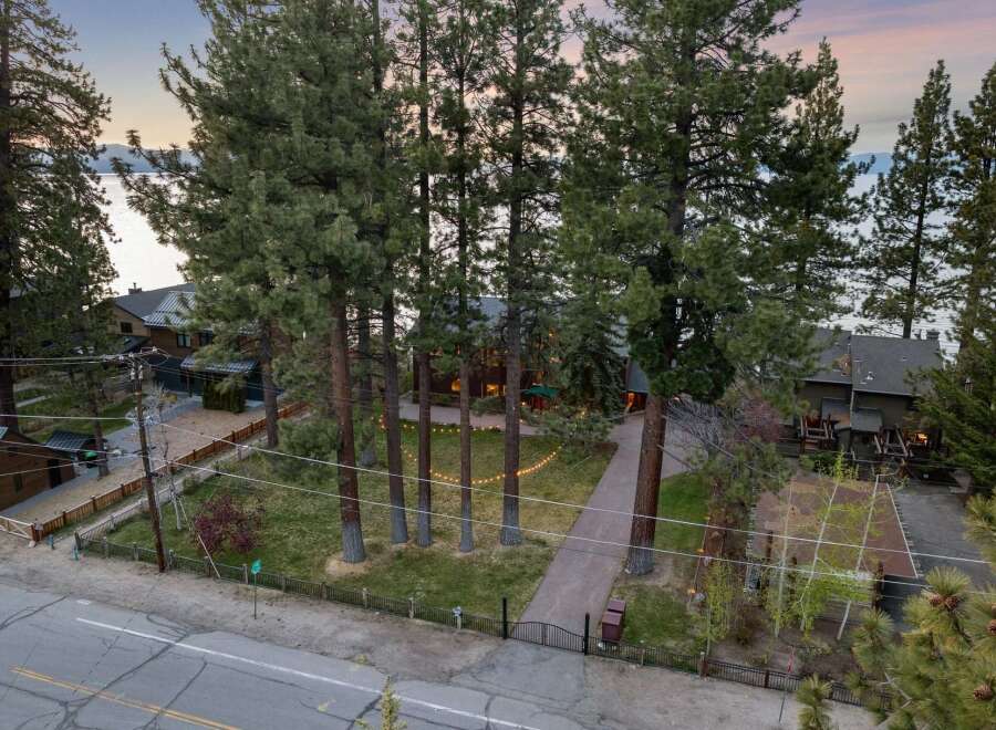 Experience luxury living in this stunning lakefront property, nestled amidst towering pine trees.