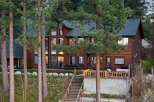 Experience luxurious living in this stunning multi-level wooden home, nestled amongst towering pine trees.