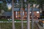 Experience luxury living in this stunning lakefront home, nestled amongst towering pine trees.