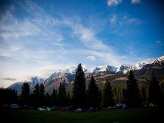 Experience the great outdoors with this stunning campsite nestled at the base of majestic, snow-capped mountains.