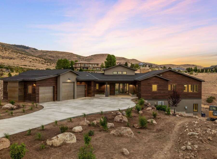 Experience modern luxury in this stunning contemporary home nestled in a picturesque hillside setting.