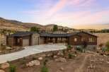 Experience modern luxury in this stunning contemporary home nestled in a picturesque hillside setting.