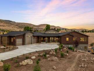 Experience modern luxury in this stunning contemporary home nestled in a picturesque hillside setting.