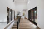 Experience modern luxury in this stunning entryway featuring soaring ceilings and abundant natural light.