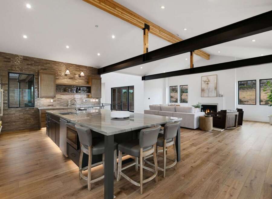 Experience modern luxury in this open-concept living space, featuring a stunning gourmet kitchen with a large island and sleek cabinetry.