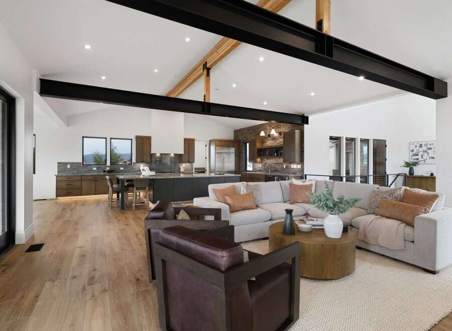 Experience modern luxury in this open-concept living space, featuring a gourmet kitchen with sleek cabinetry and a spacious island perfect for entertaining.