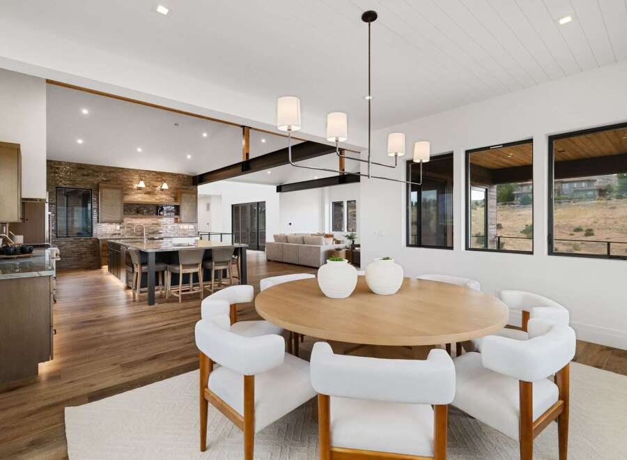 Experience modern luxury in this open-concept living space, featuring a gourmet kitchen with a large island and a sophisticated dining area.