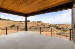 Enjoy breathtaking panoramic views from this expansive covered deck, perfect for outdoor entertaining or quiet relaxation.