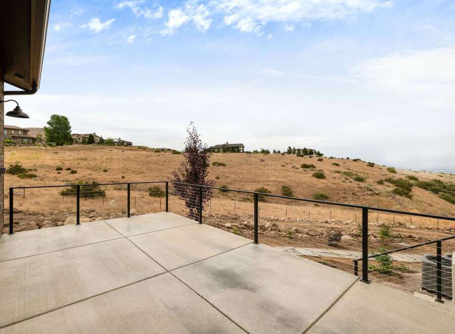 Enjoy breathtaking panoramic views from this expansive concrete patio, perfect for entertaining or quiet relaxation.