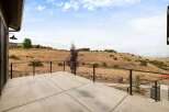 Enjoy breathtaking panoramic views from this expansive concrete patio, perfect for entertaining or quiet relaxation.